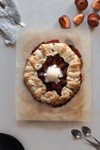 Baked plum galette served with vanilla ice cream.