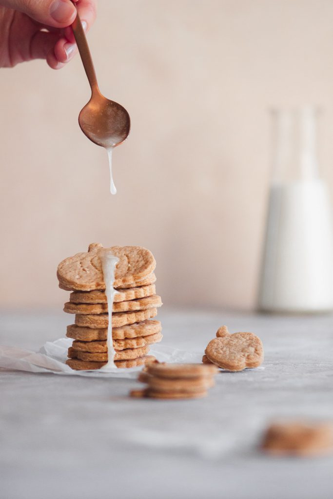 A pile of cinnamon sugar cookies drizzled with lemon icing.