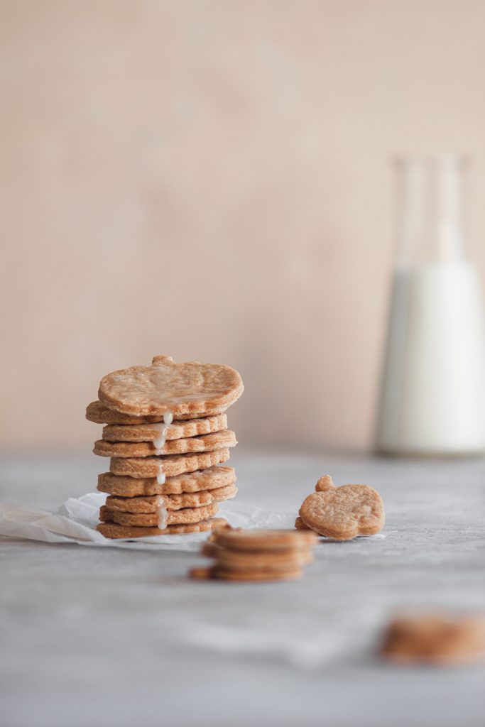 A pile of cinnamon sugar cookies with lemon icing dripping off them.