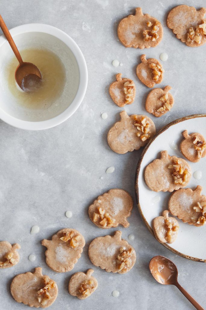 Cinnamon sugar cookies decorated with lemon icing and walnuts.