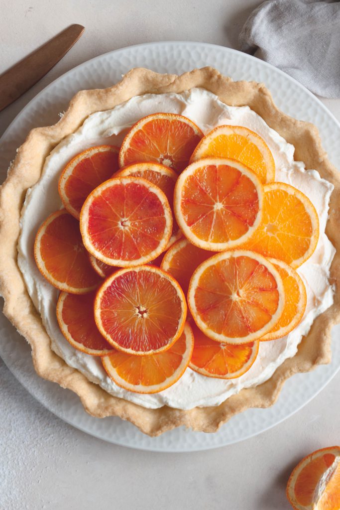 An overhead close-up on the cake with slices of fresh citrus fruit.